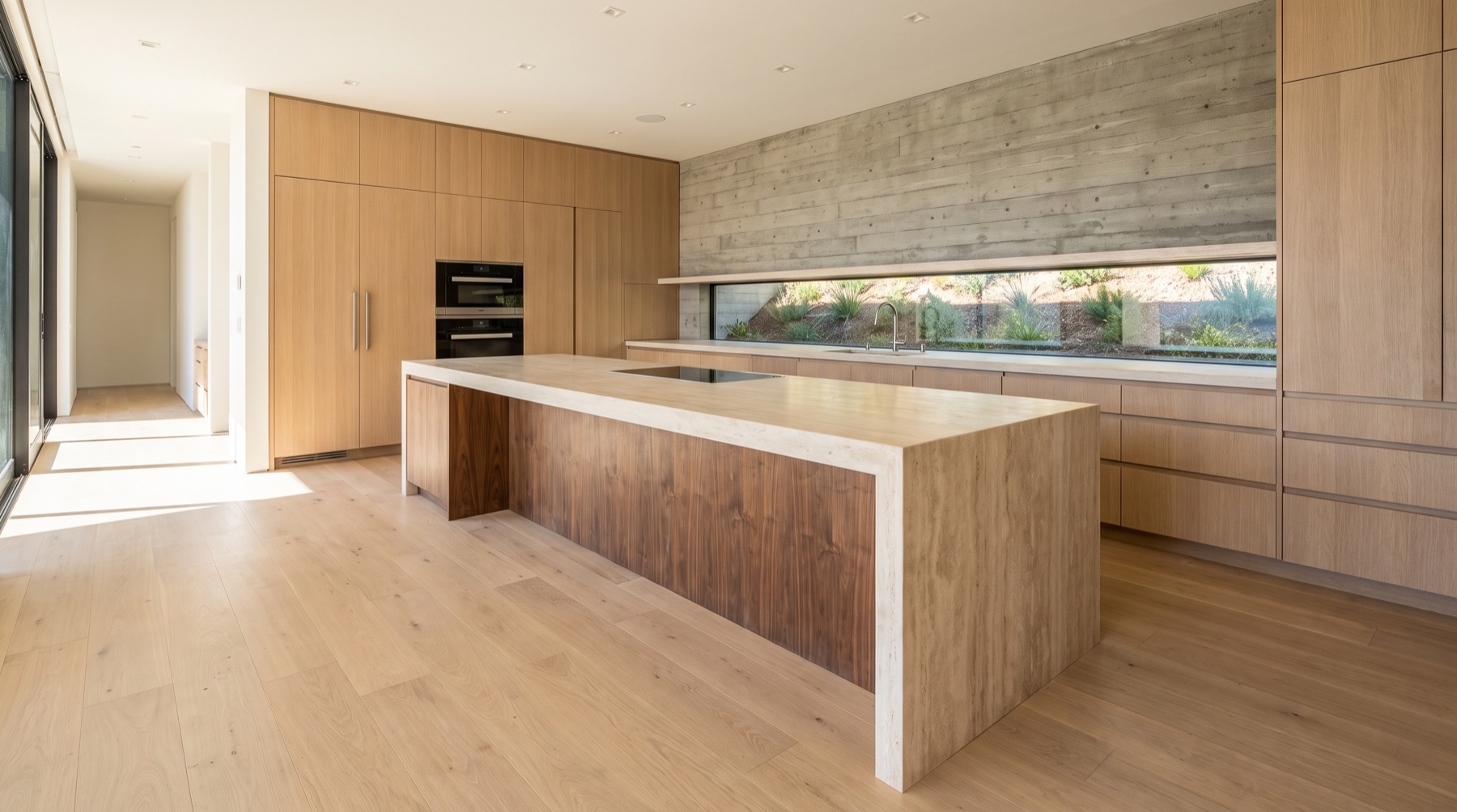 Kitchen with a travertine island and white oak cabinetry