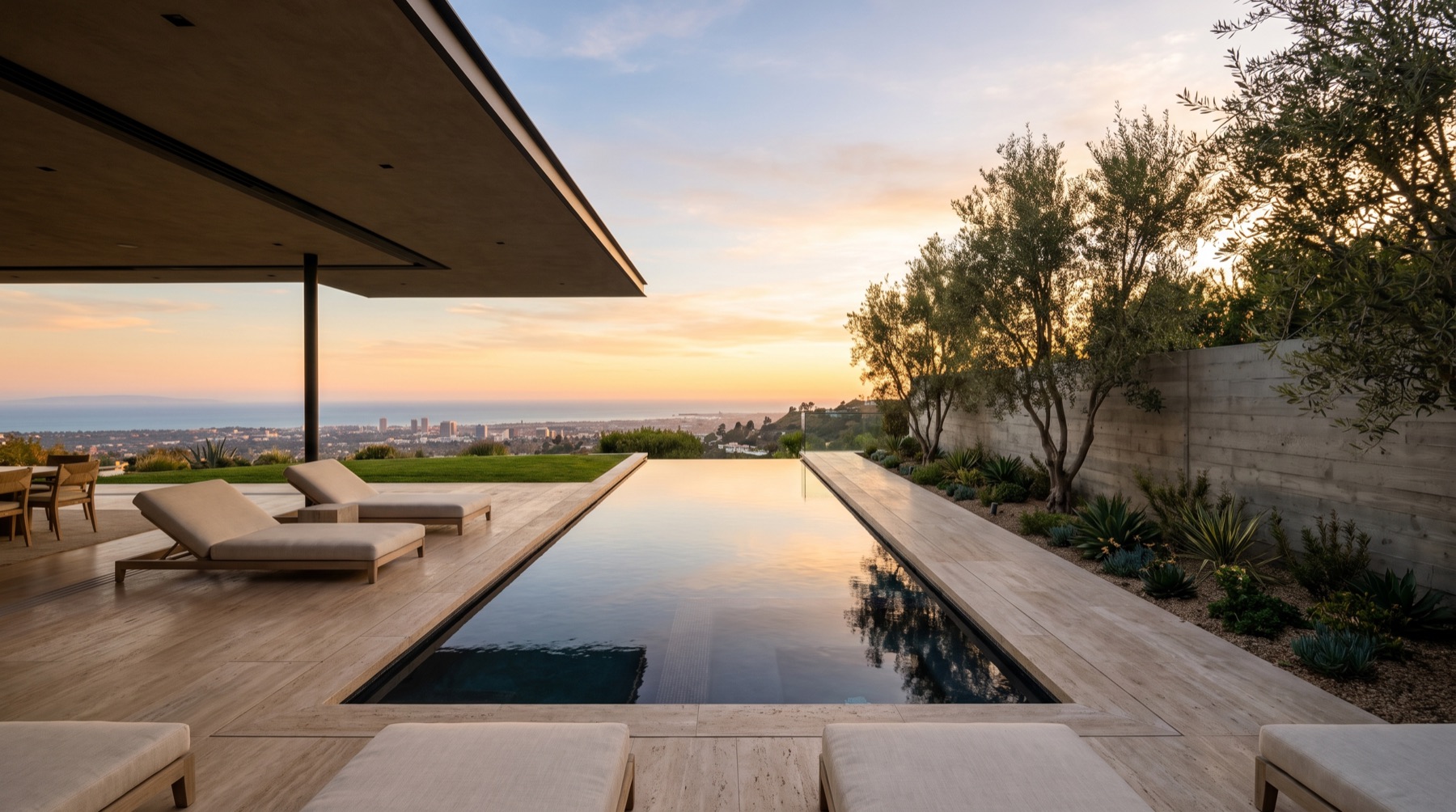 Infinity pool and terrace at golden hour above the city